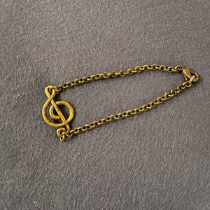 G clef brass colored bracelet